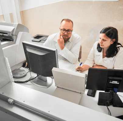 doctor and assistant taking notes about computer data
