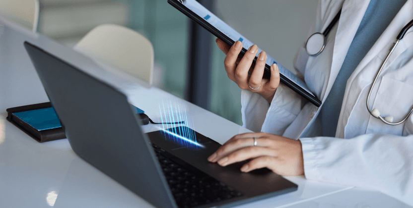 doctor using computer system on laptop and tablet